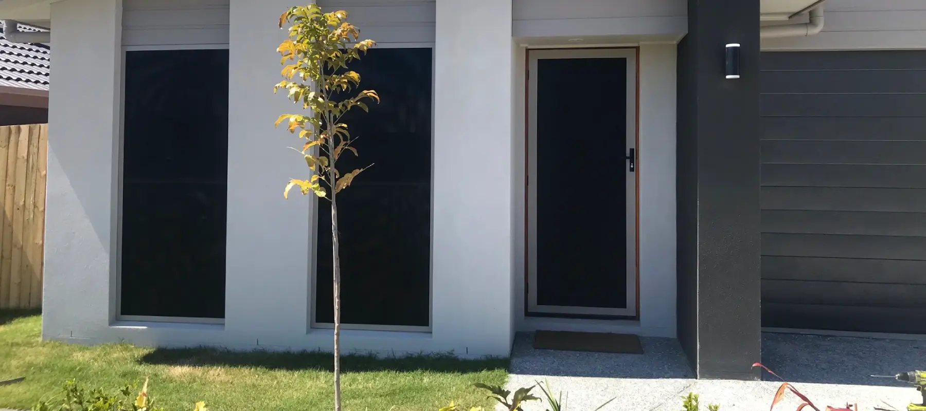 IntrudaGuard security window screens on the front of a home