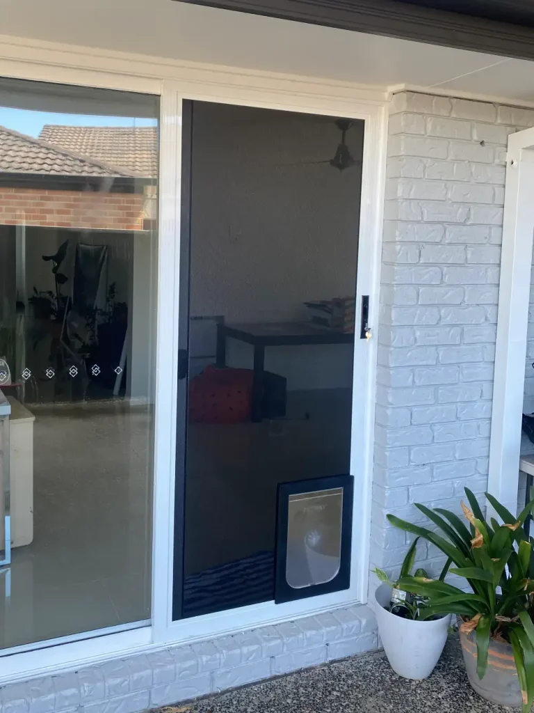 Pet door in an Amplimesh sliding door